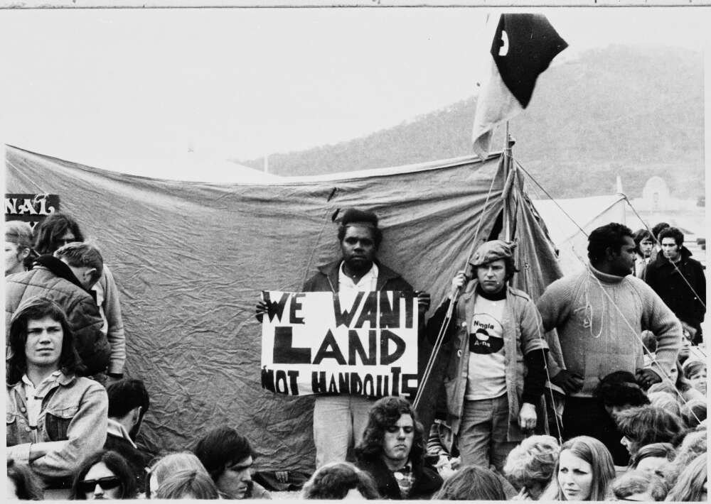 Demonstration with 'We want land not handouts' placard at land rights demonstration, Parliament House, Canberra, 30 July 1972