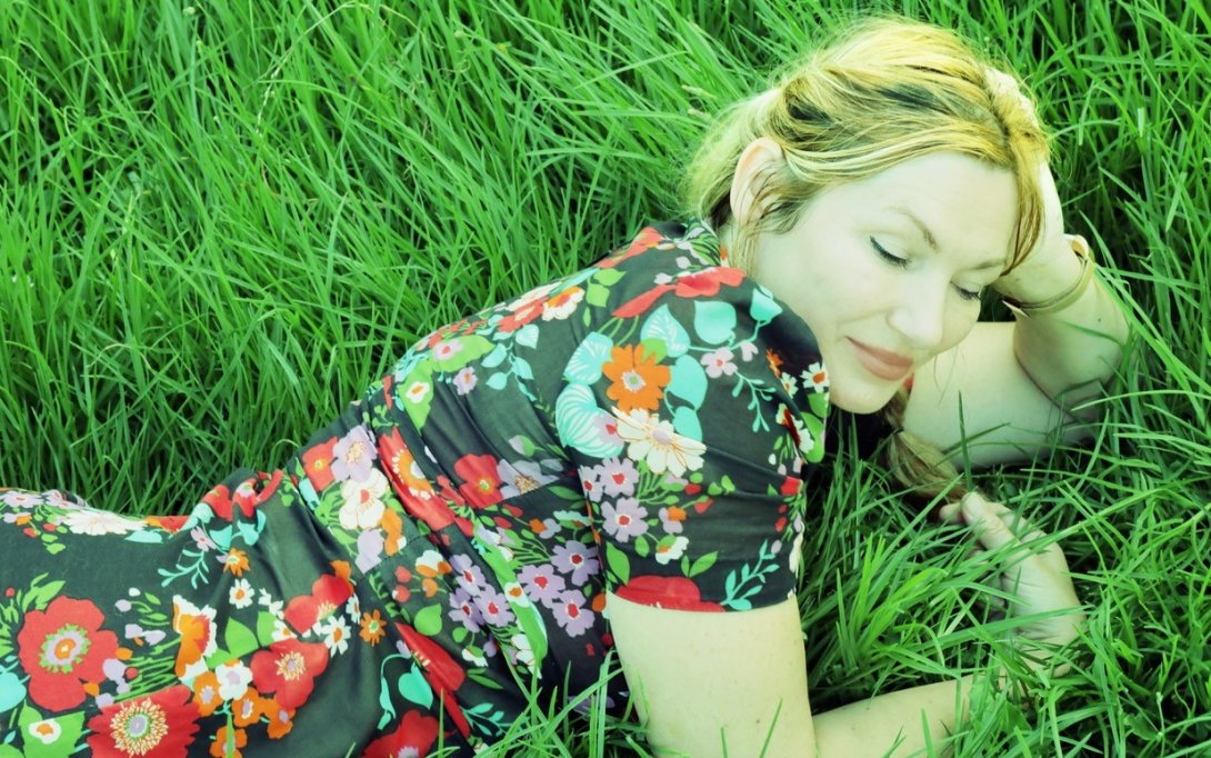 Lo Carmen lies outside on grass.