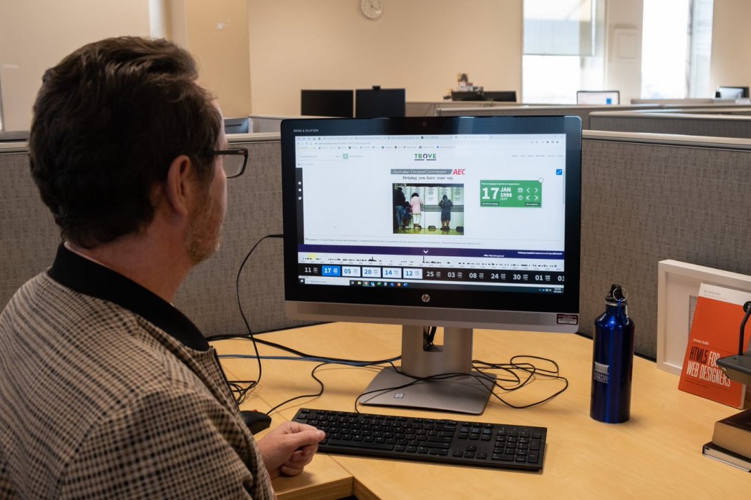 Staff member looking at an archive website on a computer