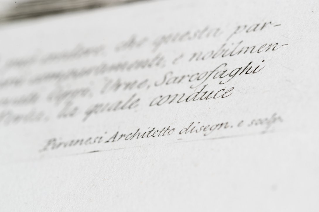 A close up image of calligraphy print on a page. Only full word in focus is 'Architetto'