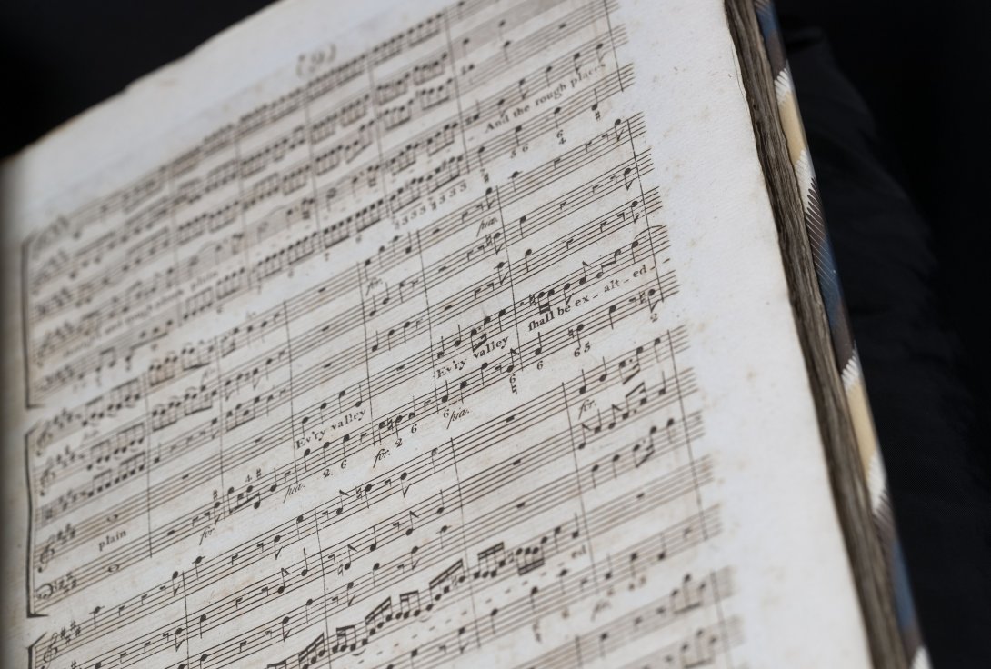 Old book open to music score
