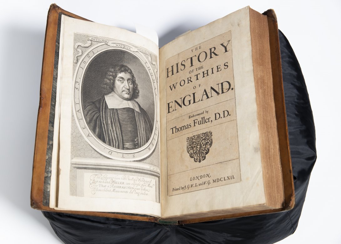 Old book open to illustrated portrait of a man and title reading 'The History of the Worthies of England'