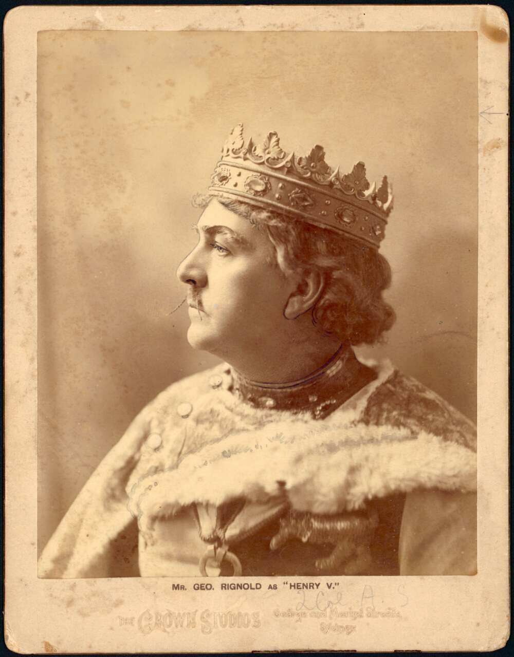 Man wearing crown and formal attire
