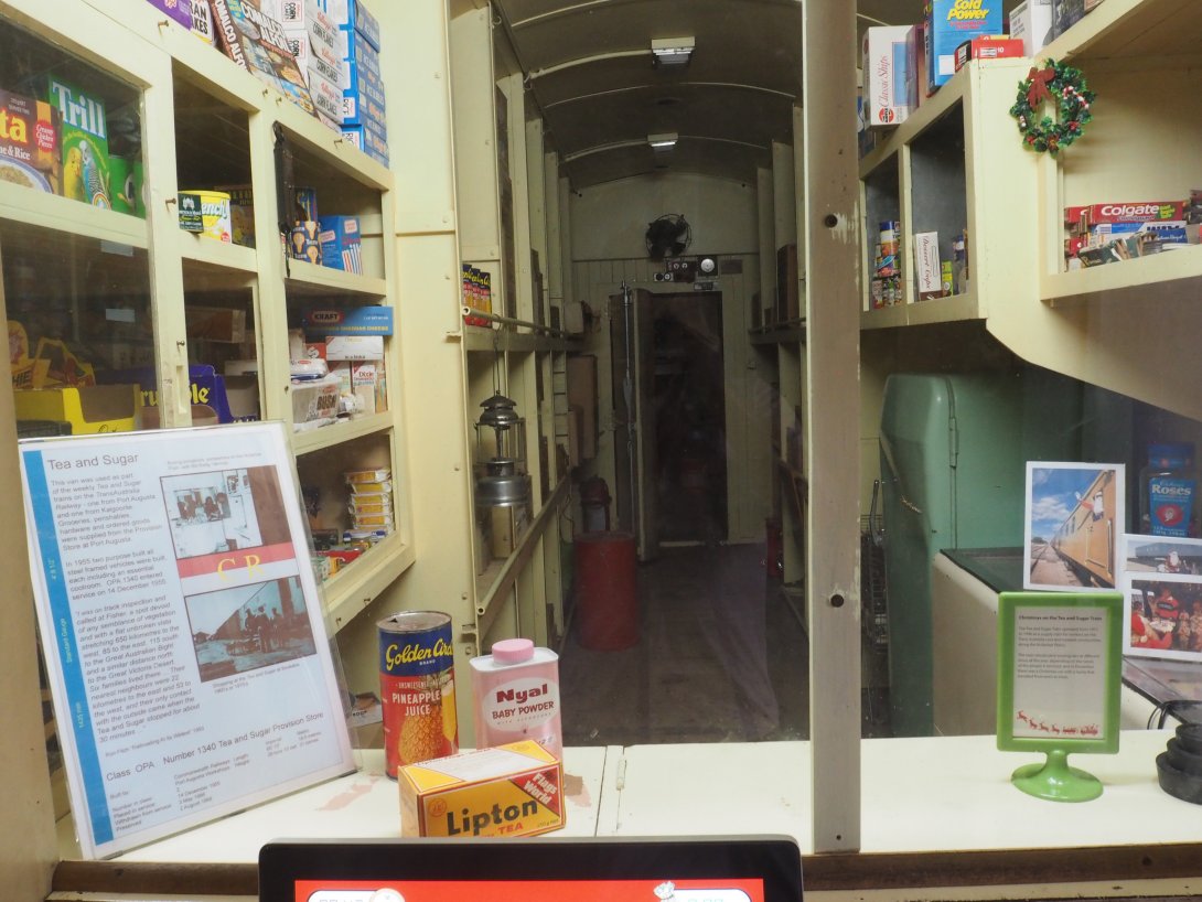 Inside of a train with shelves of tea, sugar and other pantry items