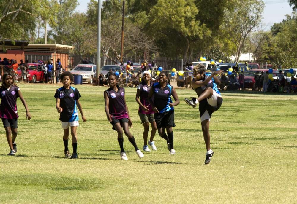Young Aboriginal women playing football