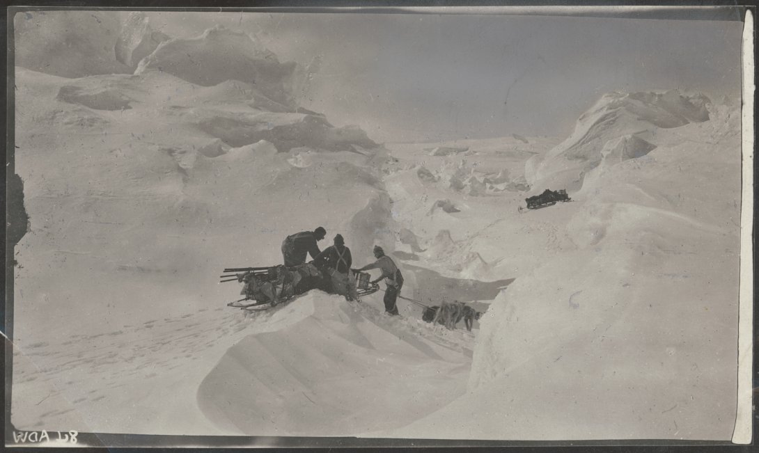Three people working in snow gully