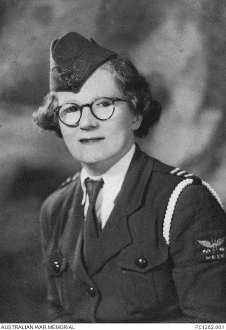 Women with glasses and short curly hair in military uniform