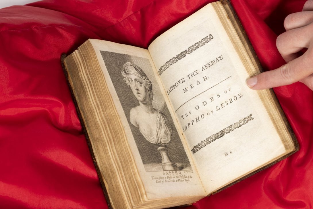 Photo of a rare book with an engraving of an ancient bust of Sappho on the left and a title on the right