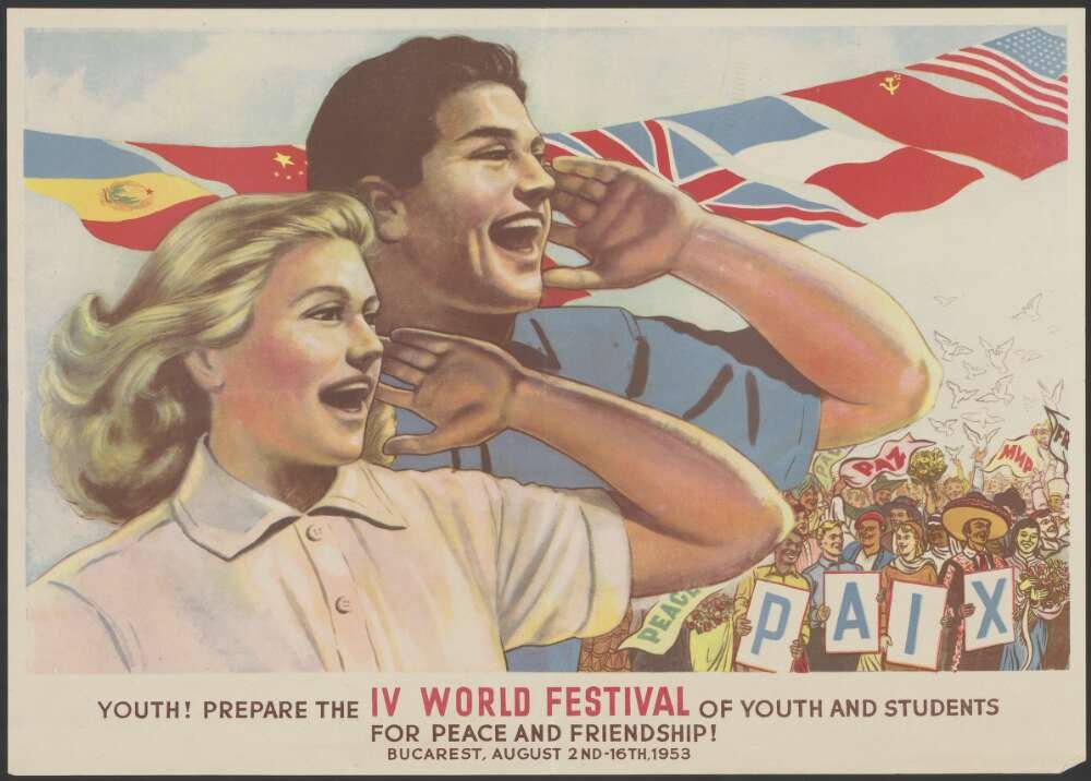 Teenage girl and boy looking to the side and yelling each with a hand around their mouth. The stand in front of flags of various countries and a crowd with signs. Text at the bottom reads 'Youth! Prepare the IV World Festival of Youth and Students for peace and Friendship'