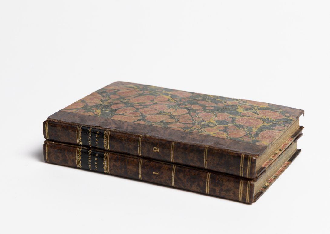 Two rare books stacked on top of each other