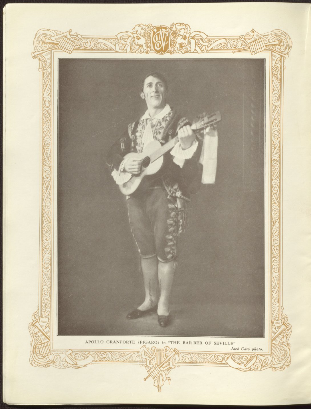 Photograph of a male performer, carrying a guitar, in Spanish costume