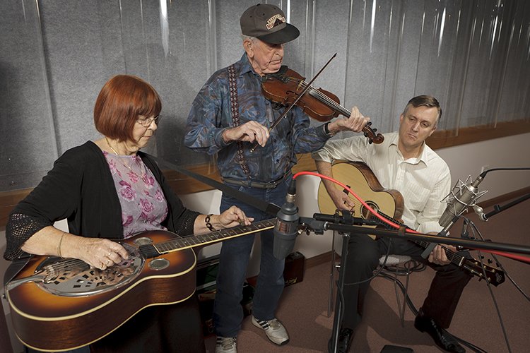 Les and June Bruton playing musical instruments with Kevin Bradley during a recording session at the National Library of Australia