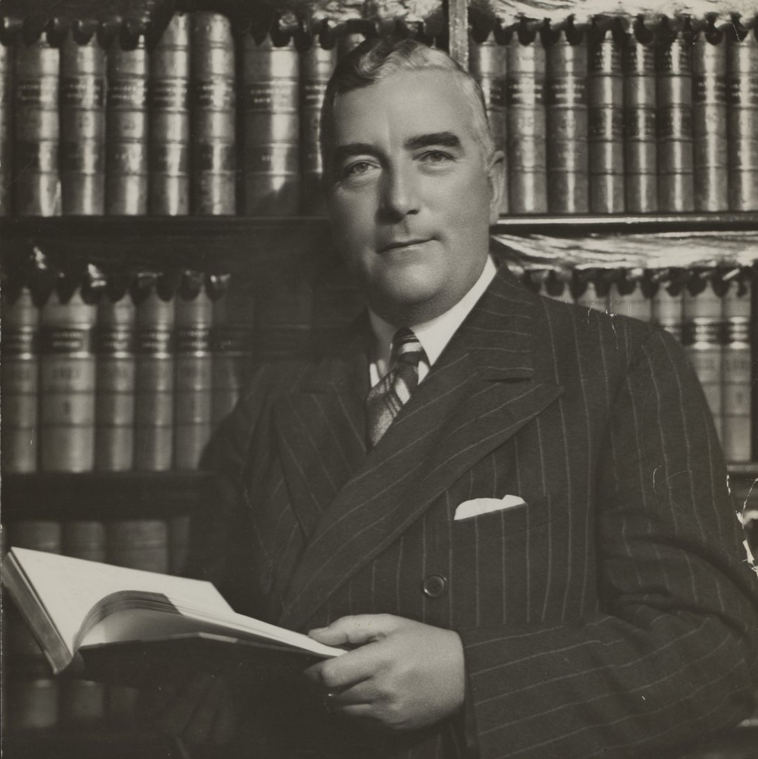 Former prime minister Sir Robert Menzies posing with a book