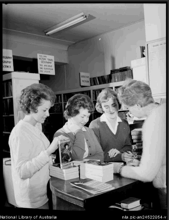 Three women at the library counter with a librarian at the Catholic Central Library, 175 Elizabeth Street, Sydney, 20 July, 1962 [picture] 